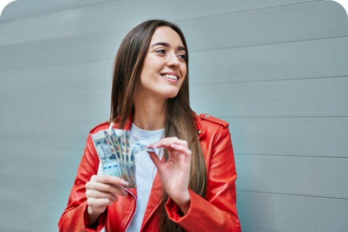 Smiling woman holding banknotes